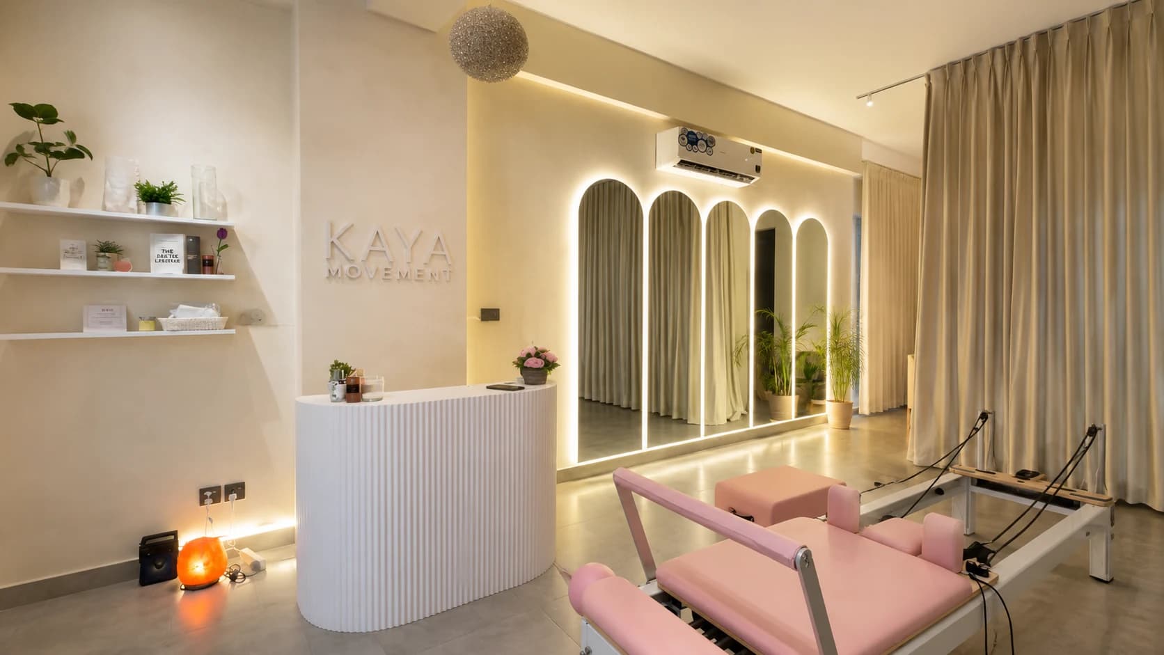 The Kaya Movement reception and studio arches, lit with warm LED edge lighting